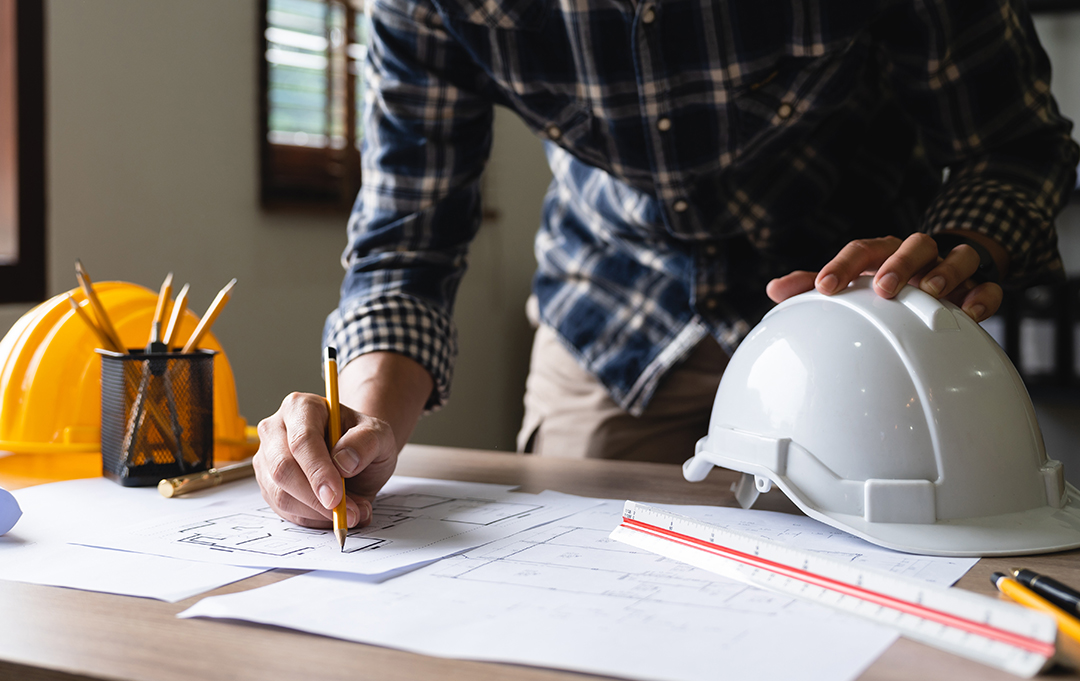 Engineer architect designer freelance work on start-up project drawing, construction plan. architect design working drawing sketch plans blueprints and making construction model. Architects concept.