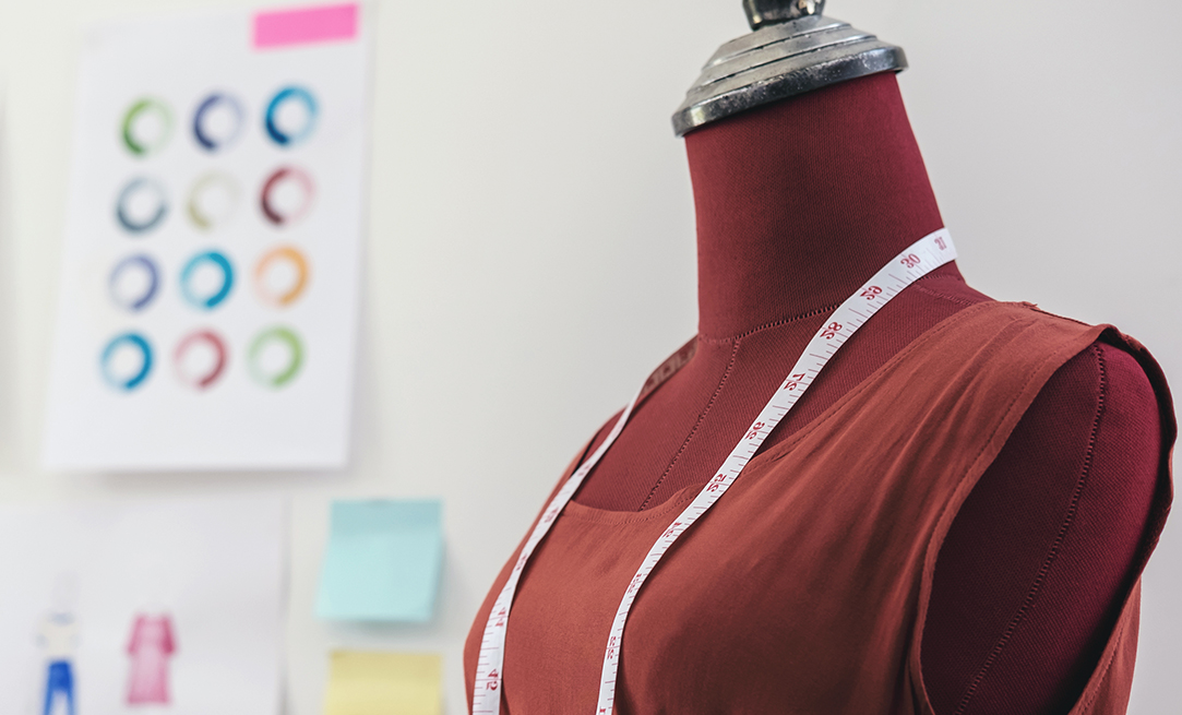 Red dummy with measuring tape in tailors studio, Creative Design