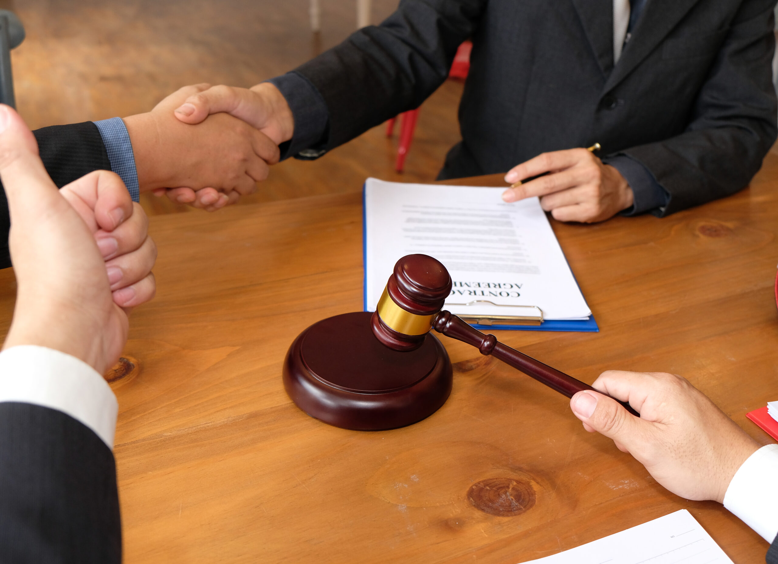 businessman shaking hands with lawyer after discussing auction c