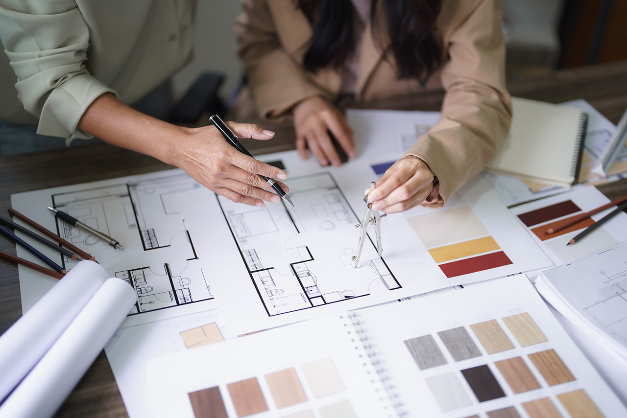 Two female architects discuss interior design building project a